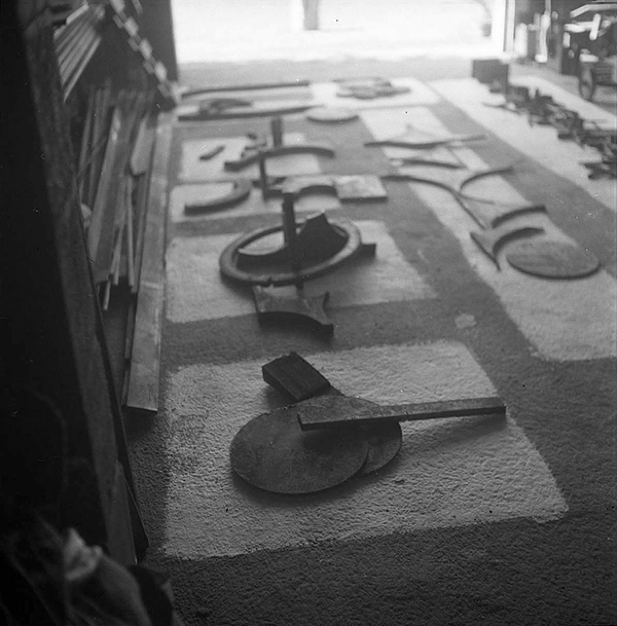Elements for <em>Albany I</em> (1959) and other sculptures laid out for assembly on the floor of David Smith&#39;s workshop in Bolton Landing, NY, c. 1959